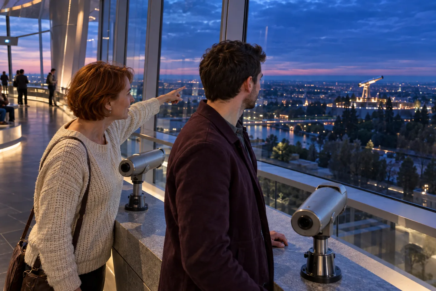 Une Européenne montre à son partenaire la ville au loin depuis une plateforme panoramique, près de deux longues-vues
